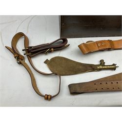 Assorted militaria including ten leather or canvas cartridge and other belts, maroon beret with 17th Lancers cap badge, modern bullet mould, leather and brass shot flask, two knives, shell cases, boomerang etc; in tin deed box