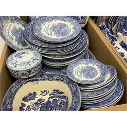 Collection of Victorian and later blue and white ceramics, largely decorated in variations of the Willow pattern, to include three large platters, two smaller platters, a number of plates of various size, bowls, jugs, cups, teapot, etc., in two boxes 