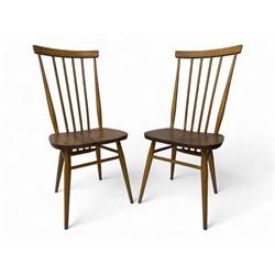 Ercol - pair of mid-20th century highback 'Windsor' chairs, curved top rail over six vertical spindles and shaped seat, on tapering cylindrical supports with stretchers