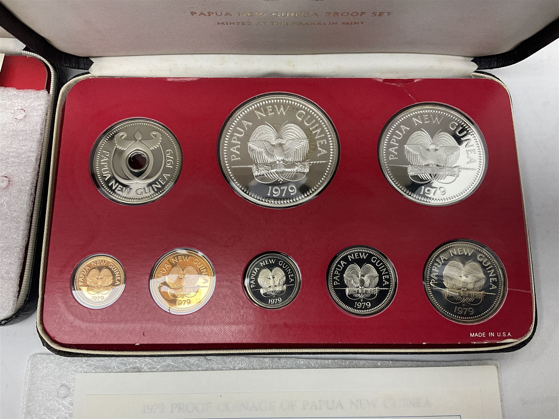 Four Papua New Guinea proof eight coin sets, from ten kina to one toea, comprising First Coinage of Papua New Guinea 1975 proof set, 1976, 1977, and 1979 proof sets, the 1977 and 1979 sets containing 925 silver ten kina and 500 silver five kina coins, all minted at the Franklin Mint, cased with certificates (4)