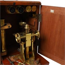 Late 19th/early 20th century Negretti and Zambra London brass microscope, with lenses, in mahogany travel case, together with a small brass field microscope and a set of prepared specimen slides