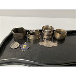 Four hallmarked silver napkin rings (total weight 83g) ebonised tray with hallmarked silver plaque with foliate engraving and two hallmarked silver pendants including an enamel Huddersfield Schools example 