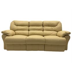 Three seat sofa upholstered in cream leather with end recliners