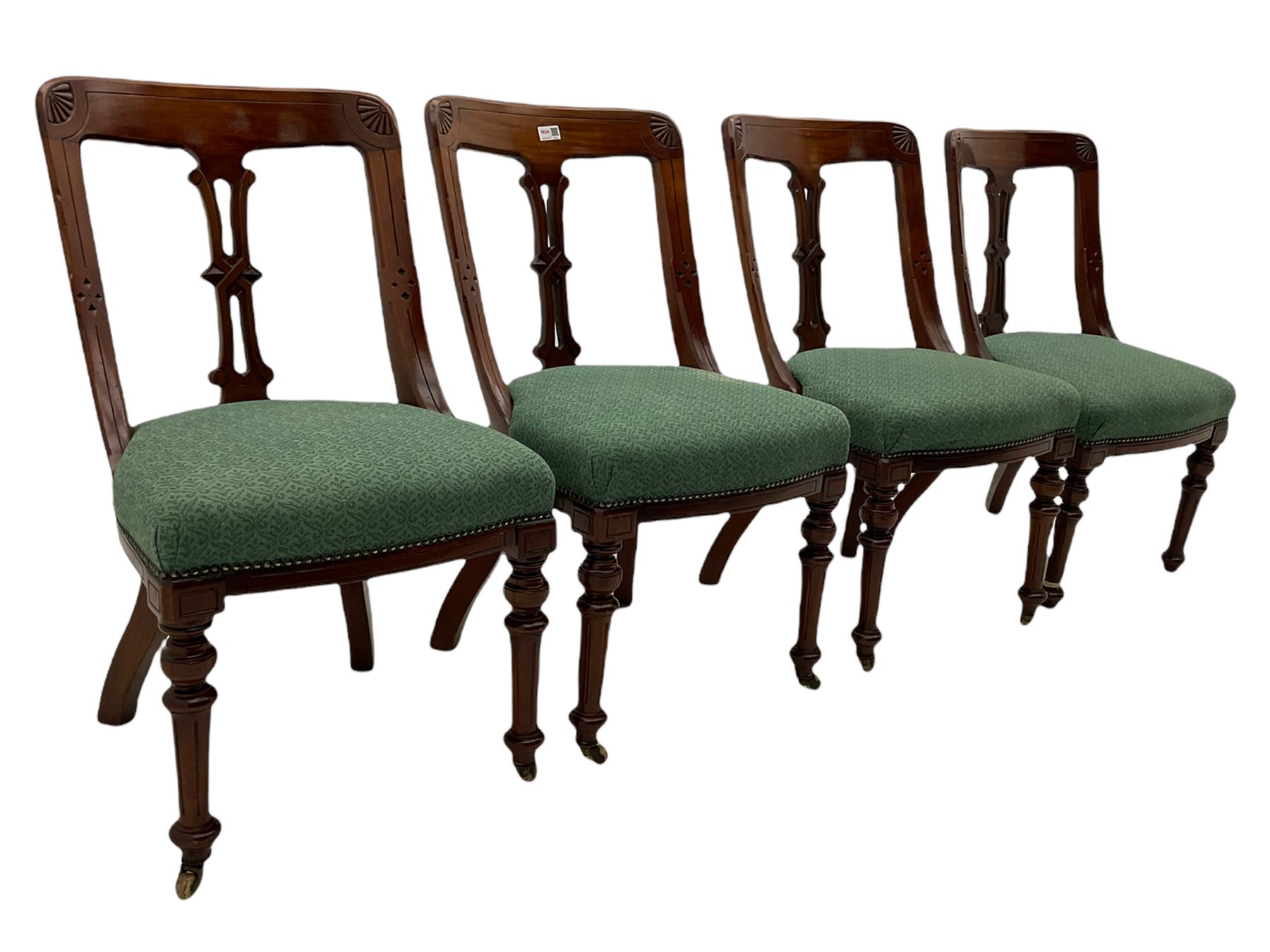 Set of four Victorian mahogany spoon back dining chairs, upholstered seats