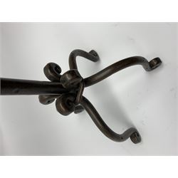 A patinated wrought iron five branch candelabra, on four scroll feet, H60cm 