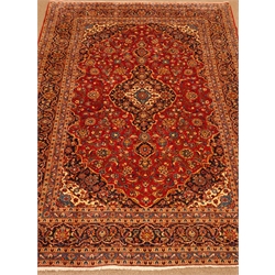  Kashan red ground rug, central medallion, floral field, repeating border, 347cm x 243cm  