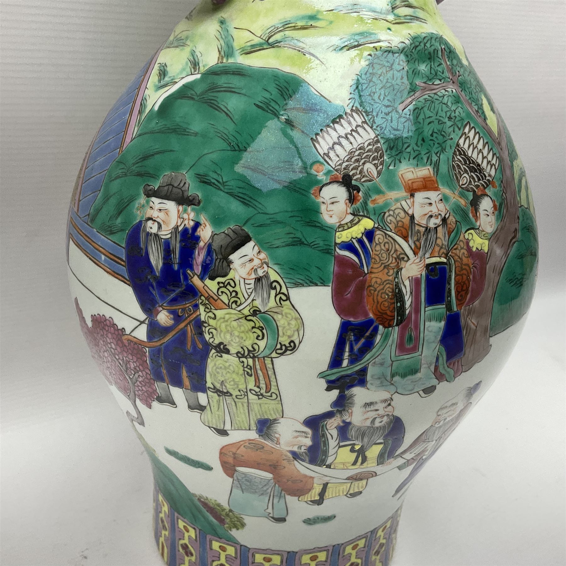 20th century Chinese Famille Rose vase, of baluster form with flared lobed rim and twin figural handles, decorated in polychrome enamel with figures dancing and playing instruments within a garden setting, H42cm