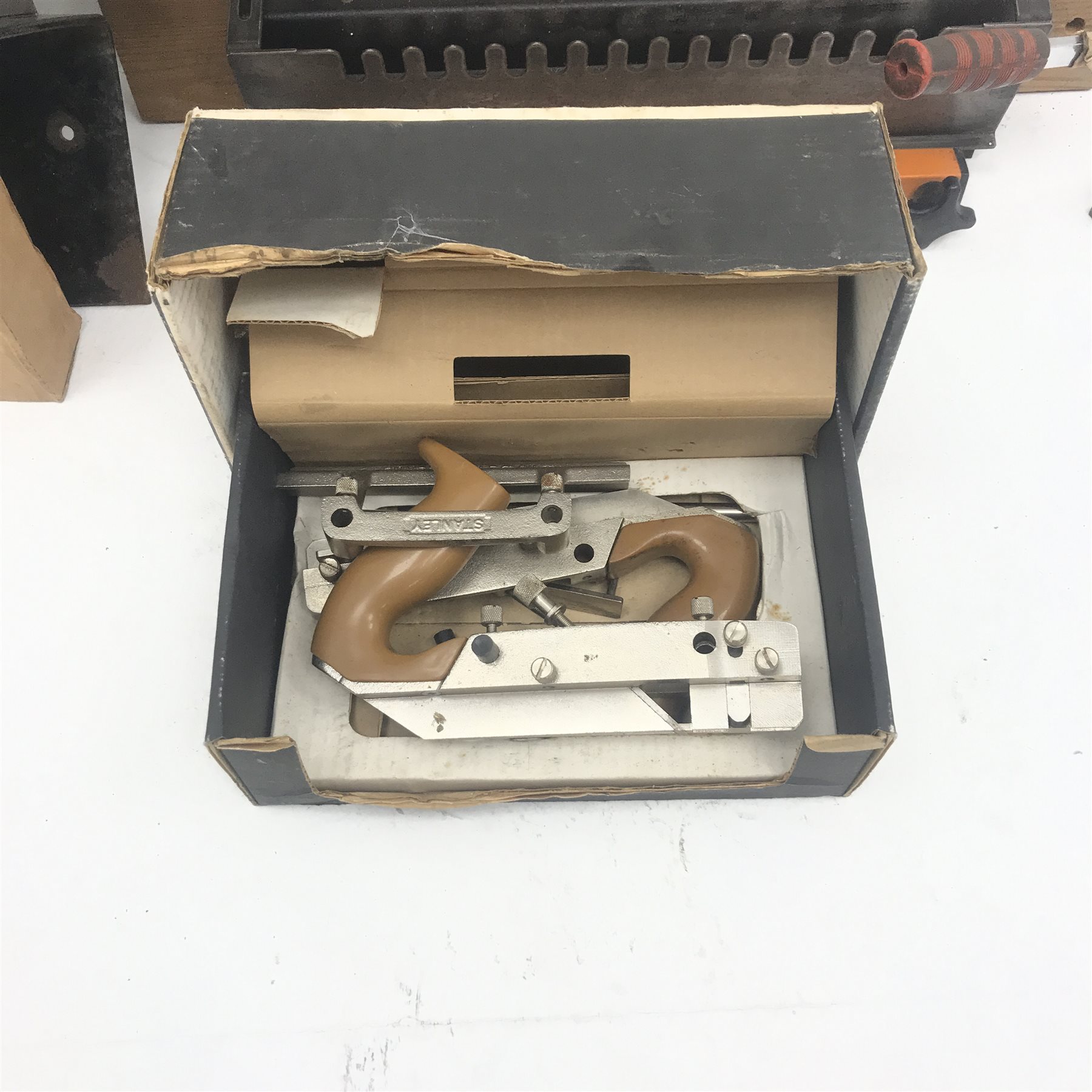 Various hand tools comprising Stanley combination plane, a button press, router jig and a Hilka 6