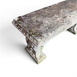 Weathered cast stone three piece garden bench, slab top raised on mythical creature supports