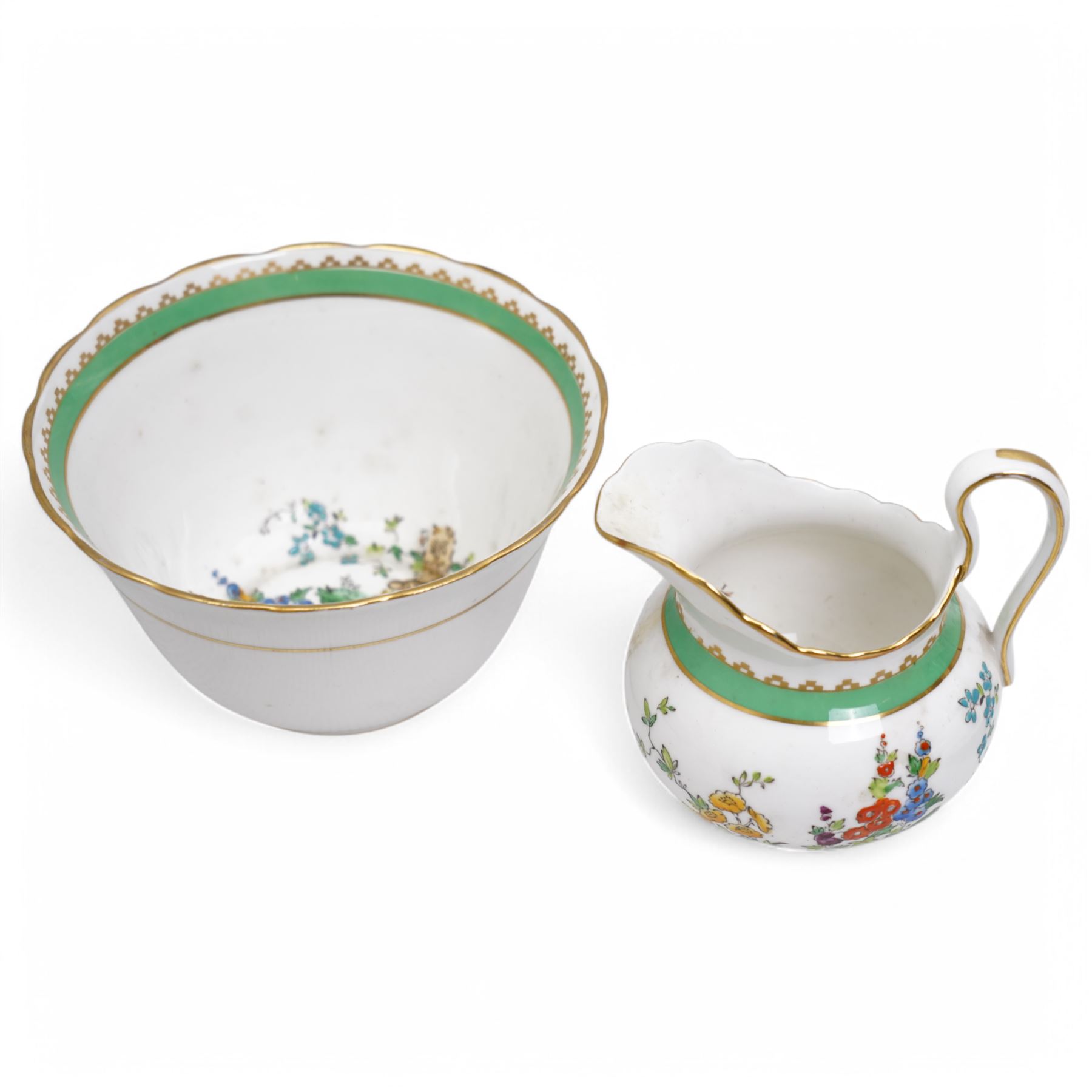 1930s Plant & Co Tuscan china tea set painted with flowers in blue, pink etc within a green border comprising twelve cups and saucers, twelve plates, two bread and butter plates, milk jug and sugar bowl (40)
