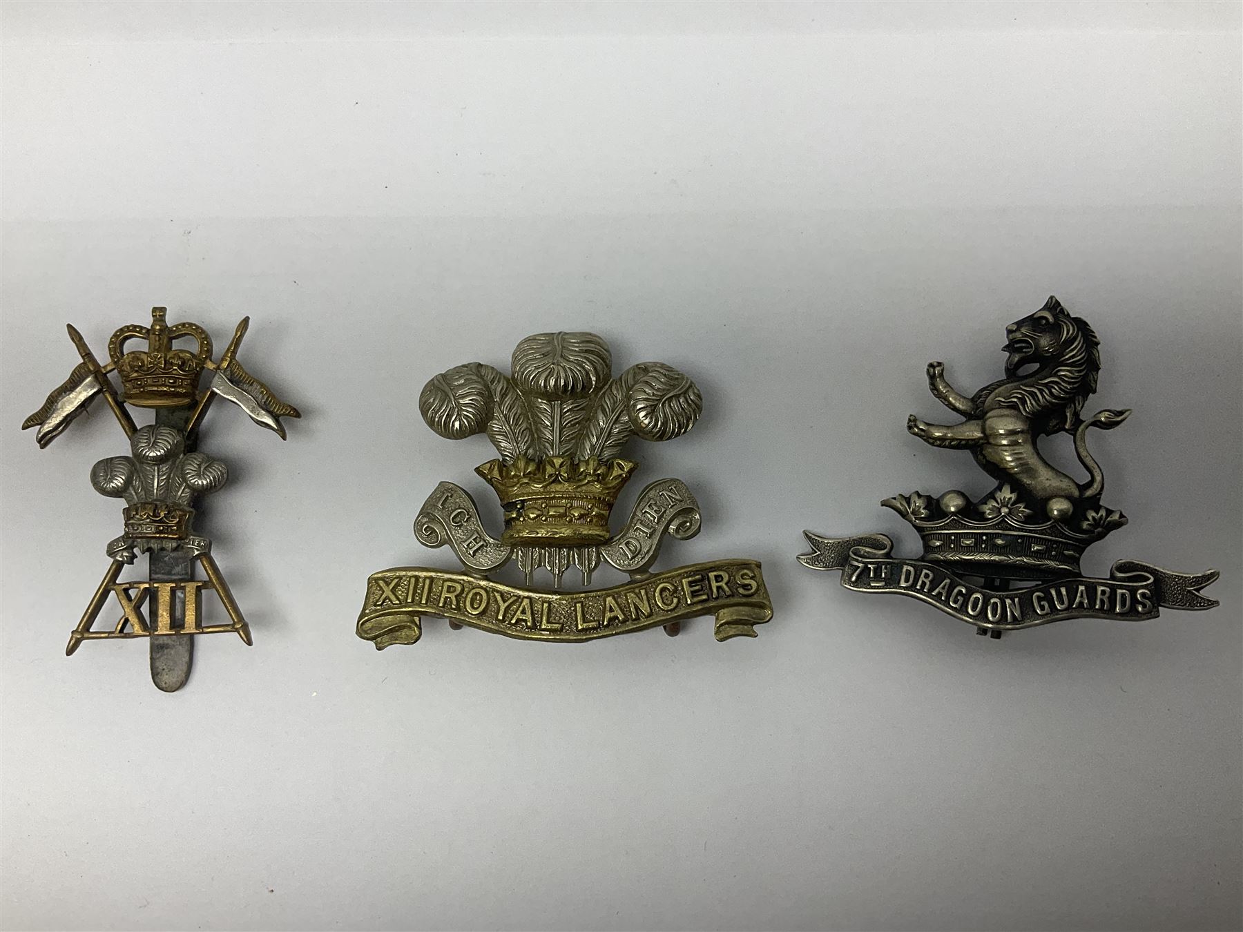 Nine Lancers metal cap badges including 9th, 12th Royals, 24th, 16th Queens and 17th; together with eight various Guards/Dragoons badges (17)