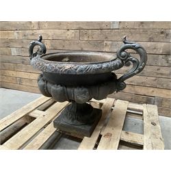 Victorian design ornate cast iron centrepiece urn, featuring two handles, raised on footed base