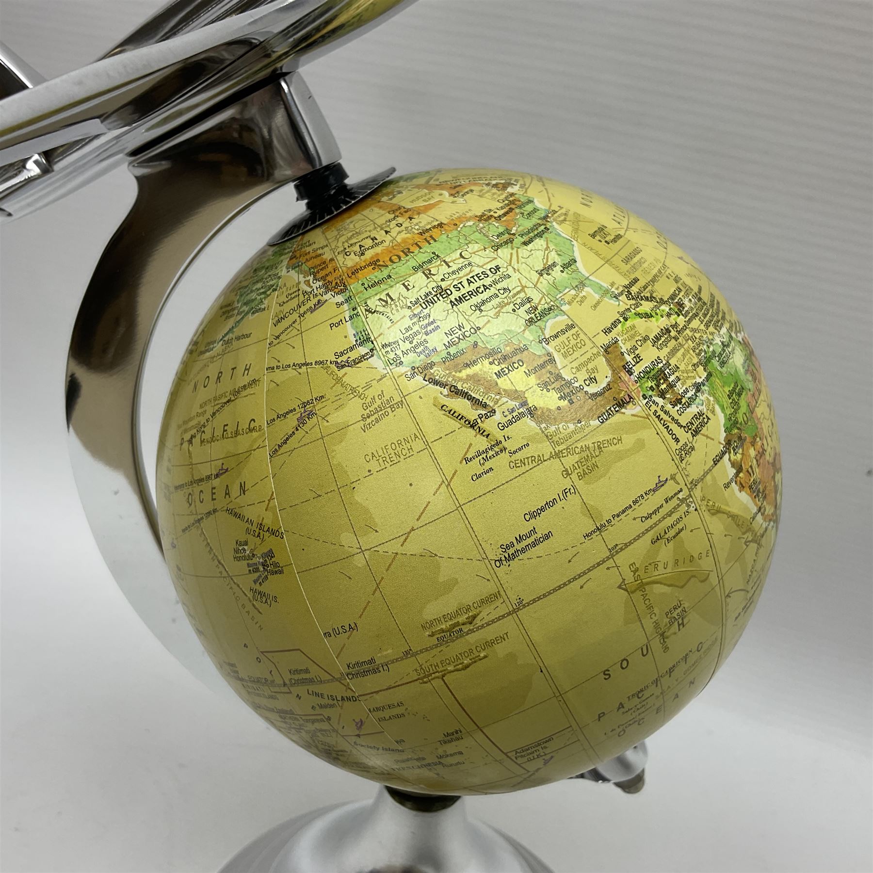 Art Deco style world globe with chrome aeroplane finial and mounts, H31cm