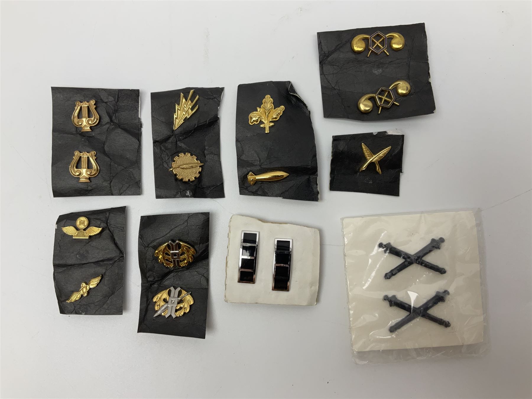 Fifty US rank badges and trade badges; WW2 and Vietnam period; predominantly on sale cards