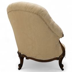 Late 19th century Victorian walnut button-back recamier, asymmetrical form, with cream damask fabric and gimp braid edging, shaped reeded apron above front and back scroll carved cabriole legs on brass castors