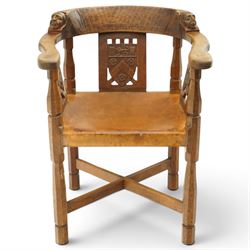 Mouseman - important oak monks chair, c1930s, the curved back inscribed with motto 'Cum Bona Voluntate Servientes' (serving with goodwill) over Trinity College Cambridge coat of arms, the shaped arms terminating with carved monks heads, each pierced side panel with Yorkshire Rose, tan leather seat on four octagonal legs joined by a cross stretcher, the back of the chair with initials ECH, with carved mouse signature, by Robert Thompson of Kilburn