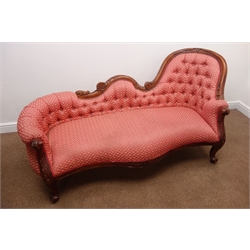  Victorian style walnut framed chaise longue, floral carved shaped cresting rail, upholstered in a deep buttoned red fabric, acanthus carved supports, L190cm  