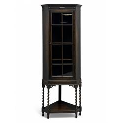Early 20th century oak corner display cabinet, the moulded canted cornice over a single gl...