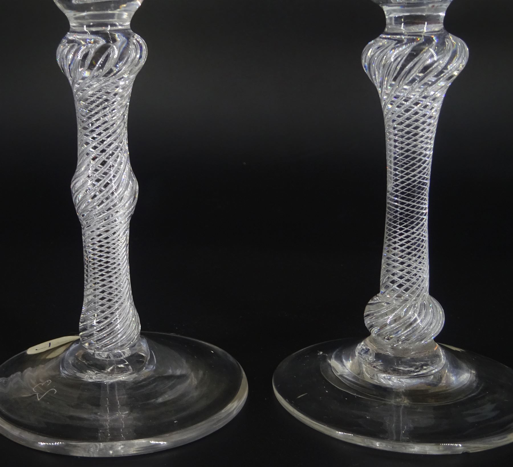 18th century ale glass, the funnel bowl raised upon a single series air twist double knopped stem and conical foot, H20cm, together with a similar smaller drinking glass, H15.5cm