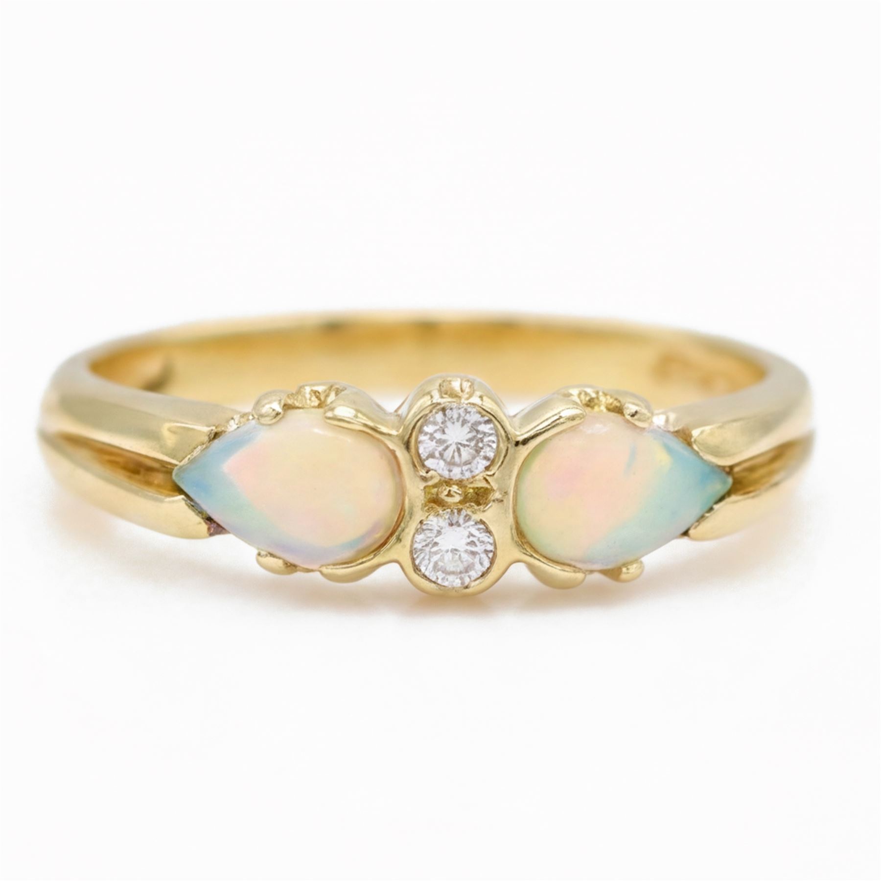 18ct gold opal and diamond four stone ring, two round brilliant cut diamonds, with a single cabochon pear cut opal set either side, London 1994