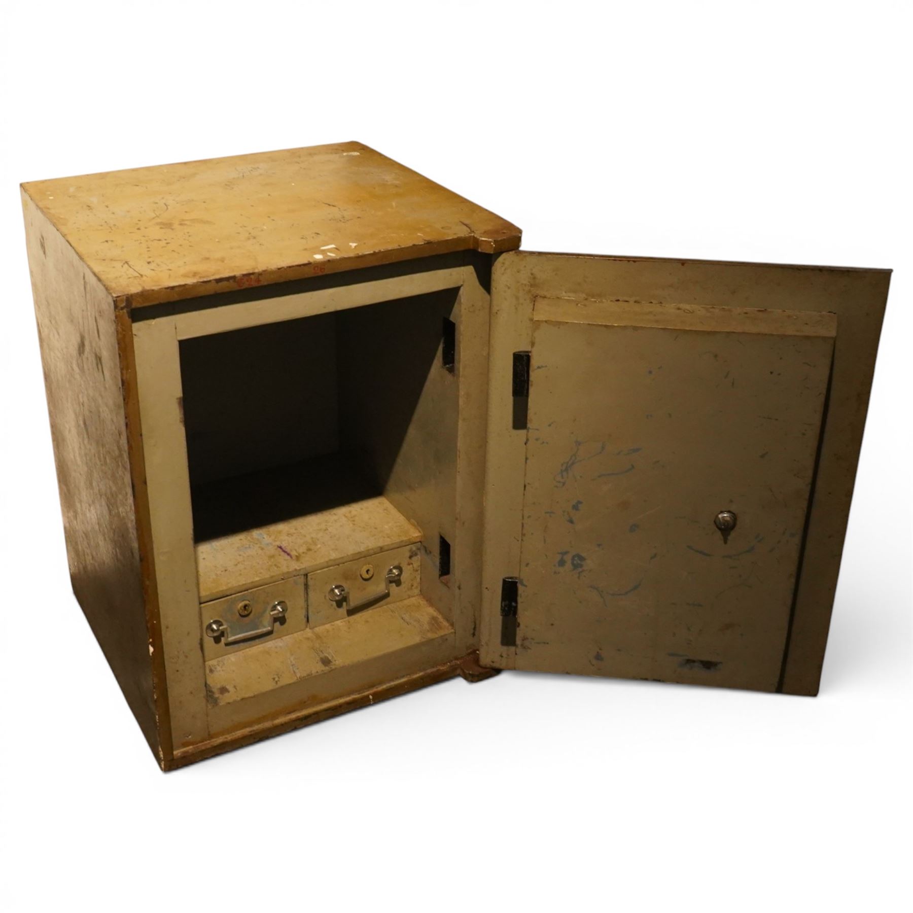 Early 20th century painted iron and steel safe, square form with moulded panel door, applied handle and lock plate with three keys, the interior fitted with twin cash drawers with recessed handles, on low cast feet