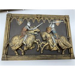 Two ceramic painted wall plaques by Marcus design, depicting a group of knights charging  in battle, H30cm W51.5cm, and two knights sword fighting, H22.5cm W32.5cm. 