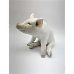 A Royal Copenhagen model of a seated pig, model no 414, H16cm