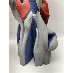 Helen Skelton (British 1933 – 2023): Two carved wooden abstract sculptures, painted in blue and red tones, largest H56cm. Born into an RAF family in 1933 in Kent and travelled the world extensively during her childhood. After settling in Bridlington, Helen immersed herself in painting, textiles, and wood sculpture, often inspired by nature's beauty. Her talent was showcased in a one-woman show at Sewerby Hall and recognised with the sculpture prize at Ferens Art Gallery in 2000. Sadly, Helen’s daughter passed away from cancer in 2005. This loss inspired Helen to donate her sculptures to Marie Curie upon her passing in 2023.