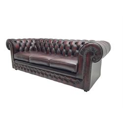 Thomas Lloyd - three seat Chesterfield sofa, upholstered in buttoned oxblood leather, on castors 