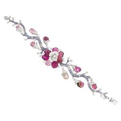 18ct white gold gemstone set floral jewellery suite, comprising necklace, pair of earrings and bracelet, each with tourmaline flower petals, round brilliant cut diamond centres and sapphire stems, stamped