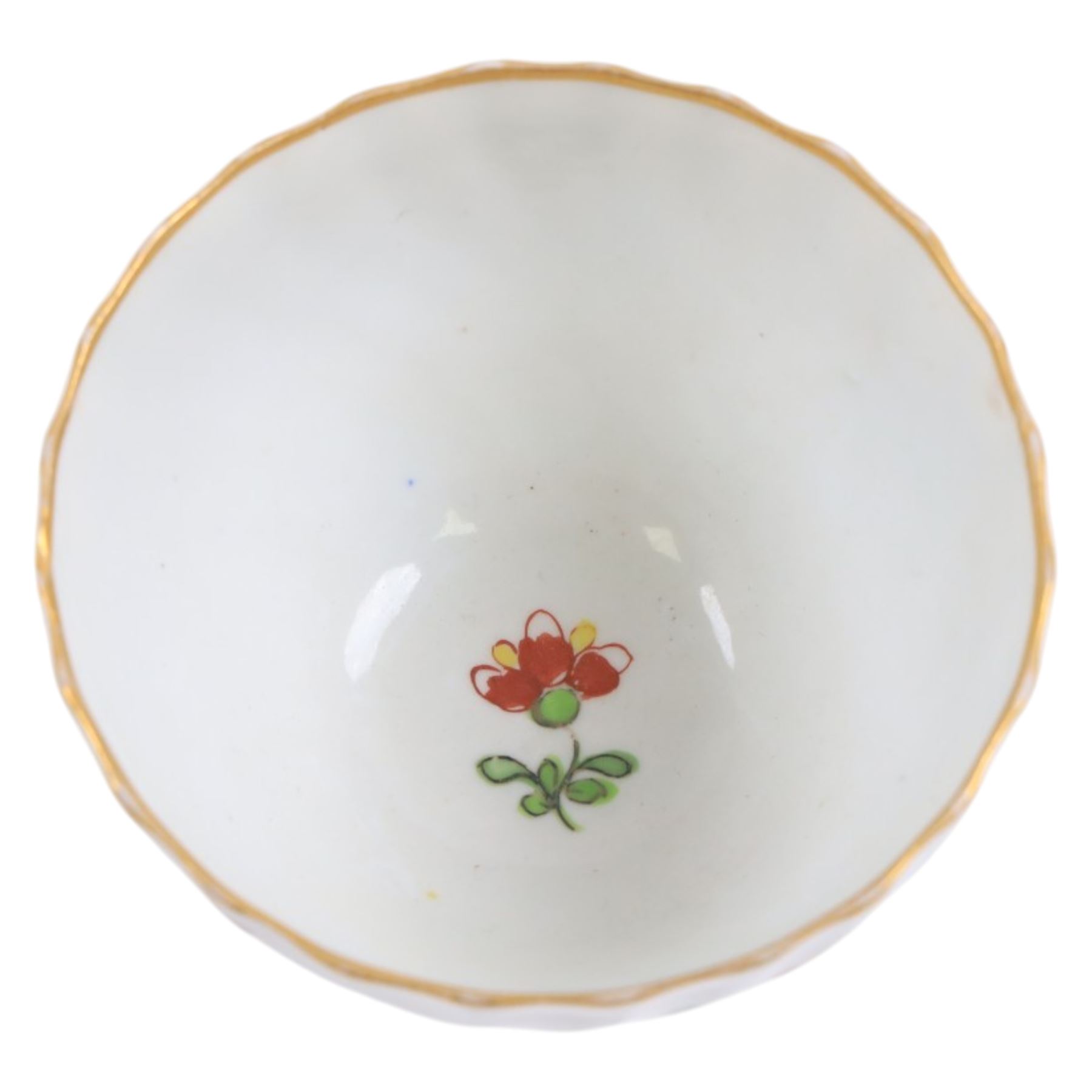 Chamberlain's Worcester teabowl and saucer, each of wrythen form decorated in the Sir Joshua Reynolds pattern, circa 1800, with long tailed Ho Ho bird perched upon green rockwork and surrounded by flowering vines, the saucer with iron red pattern number 203 beneath, teabowl H6cm D8.5cm, saucer D14cm