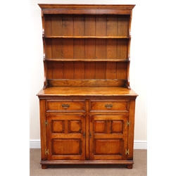  Medium oak dresser, two tier plate rack above two drawers and two panelled doors, by 'S. Cumper Ltd. Salisbury', W111cm, H187cm, D52cm  
