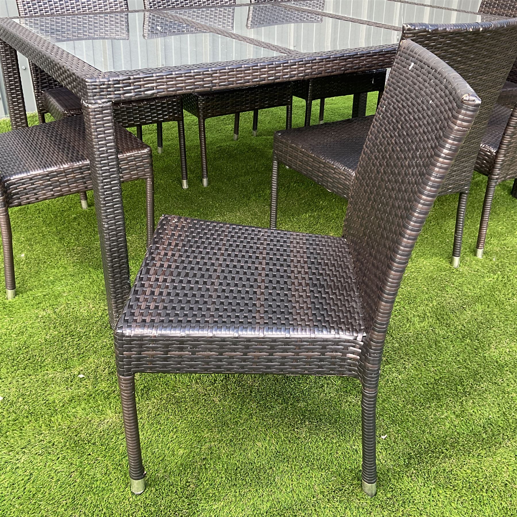 Grey rattan garden table with three glass inlays and eight chairs