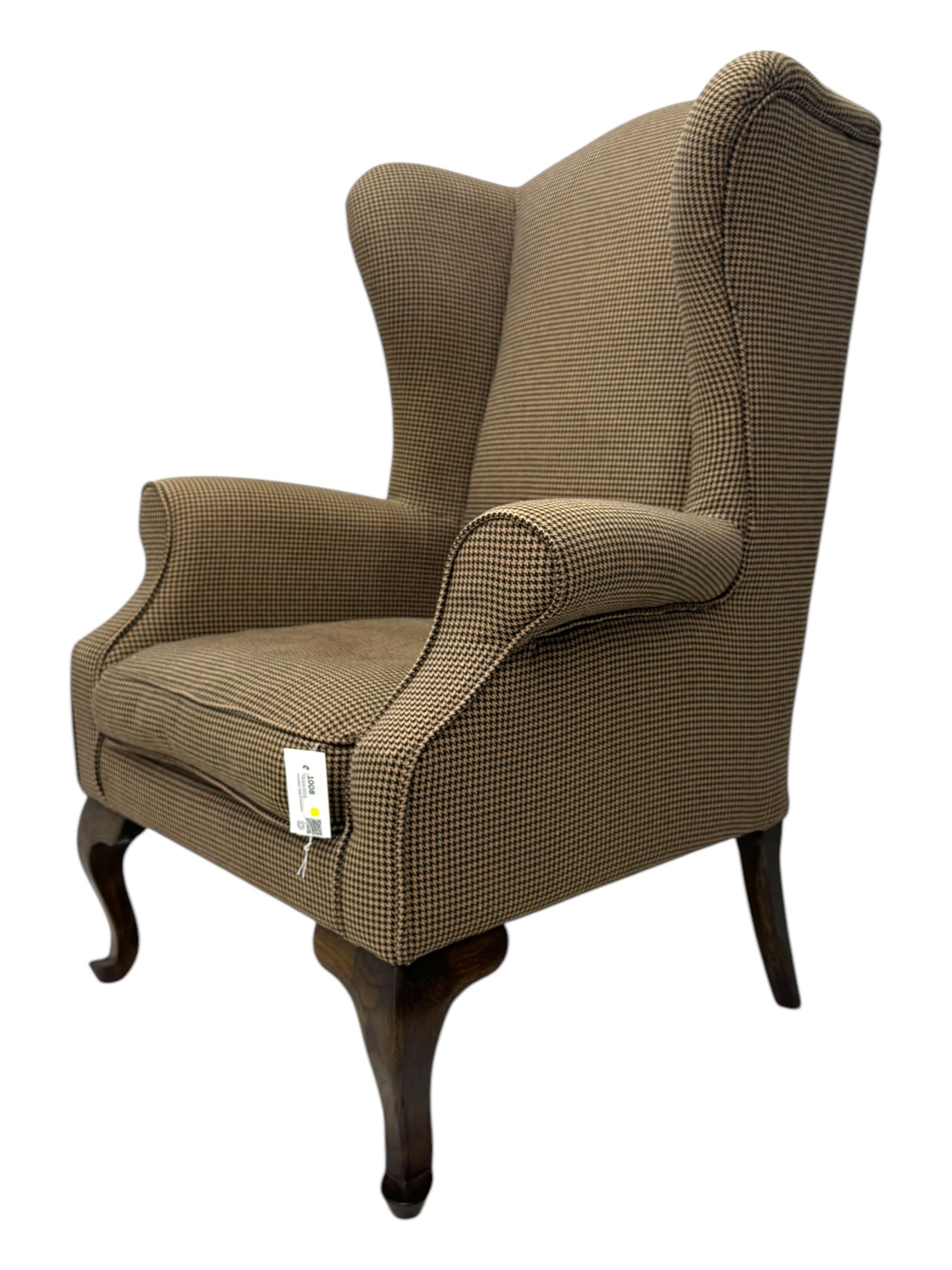 Hardwood-framed wingback armchair, upholstered in dog tooth pattern fabric, on cabriole supports 
