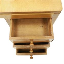 Mouseman - adzed oak kneehole dressing table with mirror, the rectangular adzed top with raised back and canted corners with fixed central pivoting mirror with scallop-carved cresting rail, over an arched recessed kneehole flanked by three graduating drawers to each side with turned knob handles, raised on octagonal feet, with carved mouse signature, by the workshop of Robert Thompson of Kilburn