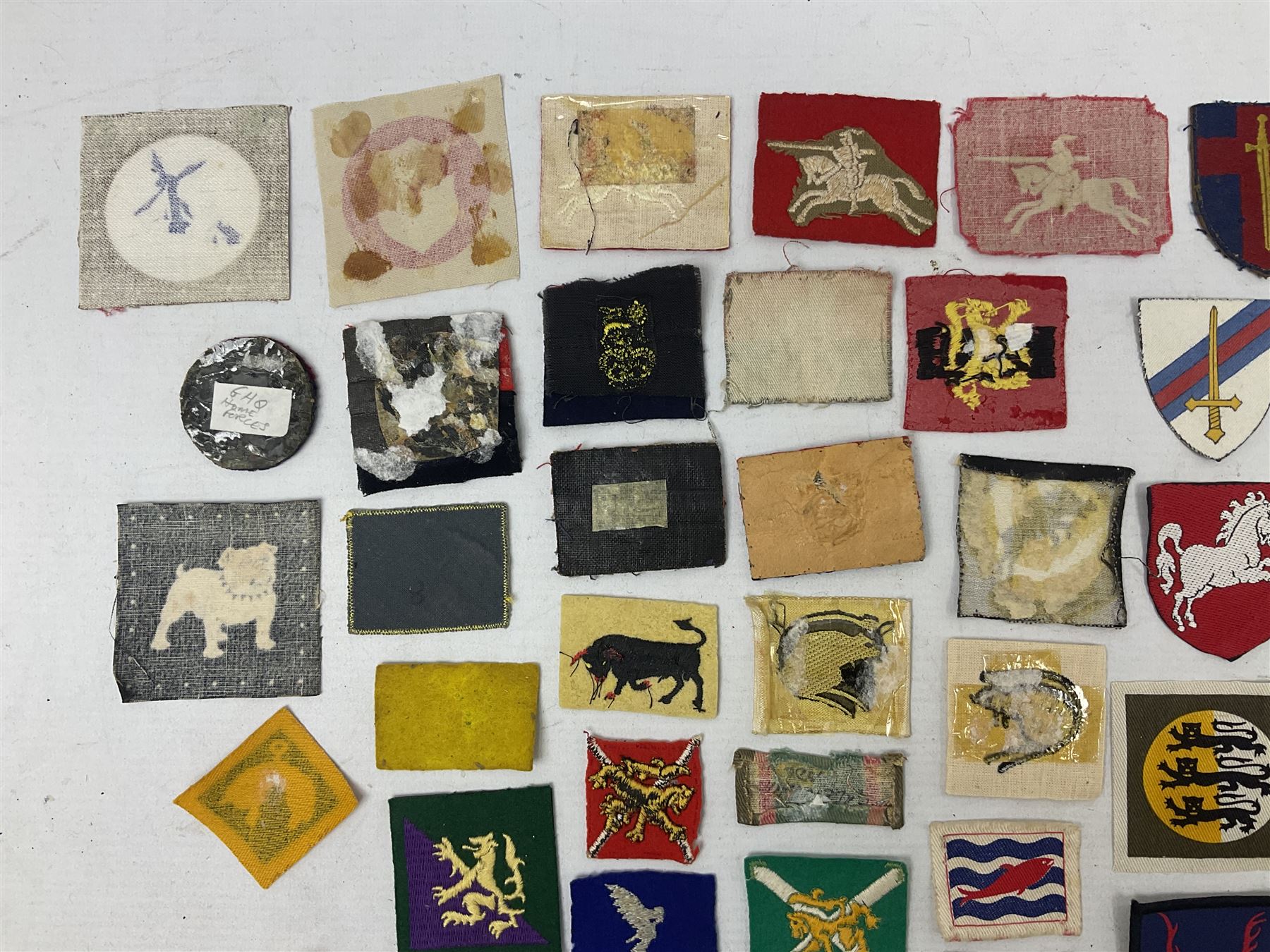 Approximately one-hundred printed and embroidered cloth badges including I, II, VIII, XI, XII and XXX Corps, Eastern Command, various Armoured Divisions, Midland, Wessex, Home Counties and 12th Infantry Brigades, Salisbury Plain, Northumberland, Hampshire, North Midland, West Riding, Essex and Suffolk Districts, Berlin & Rhine Army Troops etc