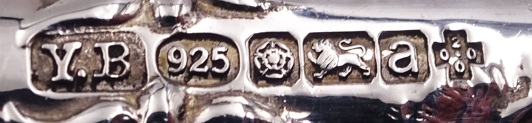 Group of silver, comprising modern silver handled letter opener, the handle decorated in low relief with Oriental scene set with pagodas, bridge and boat, hallmarked Yates Brothers, Sheffield 2000, a 1920's silver handled letter opener, hallmarked Sheffield 1928, makers mark GB, and a further silver handled letter opener, hallmarks worn and indistinct, probably Edwardian, a 20th century sauce ladle, probably American, with part fluted bowl and foliate detail to terminal, marked Sterling, an American silver spoon marked Sterling and marked for Gorham,1930's caddy spoon, an Edwardian silver handled pickle spoon, and four napkin rings, various hallmarks, dates ranging 1906 to 1924, approximate total gross weight 8.19 ozt (254.8 grams)