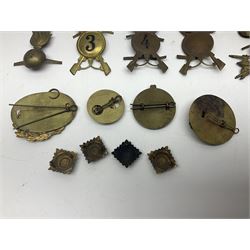 Over thirty British and Continental military metal badges; together with quantity of shoulder titles, collar dogs, rank pips, uniform buttons etc