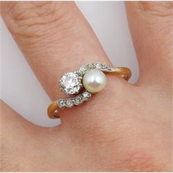 Early 20th century old cut diamond and pearl crossover ring, with diamond set scalloped design shoulders, stamped 18ct, principle diamond approx 0.35 carat