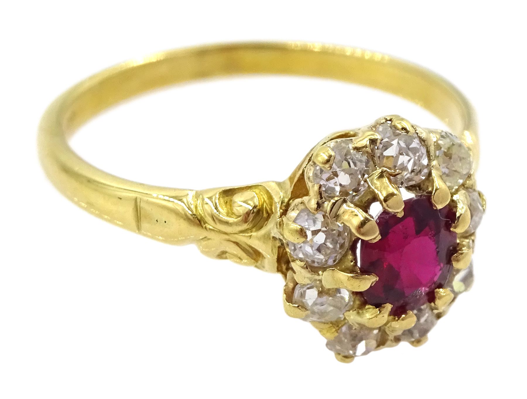 Early 20th century 18ct gold oval cut ruby and old cut diamond cluster ring, stamped, ruby approx 0.45 carat, total diamond weight approx 0.35 carat