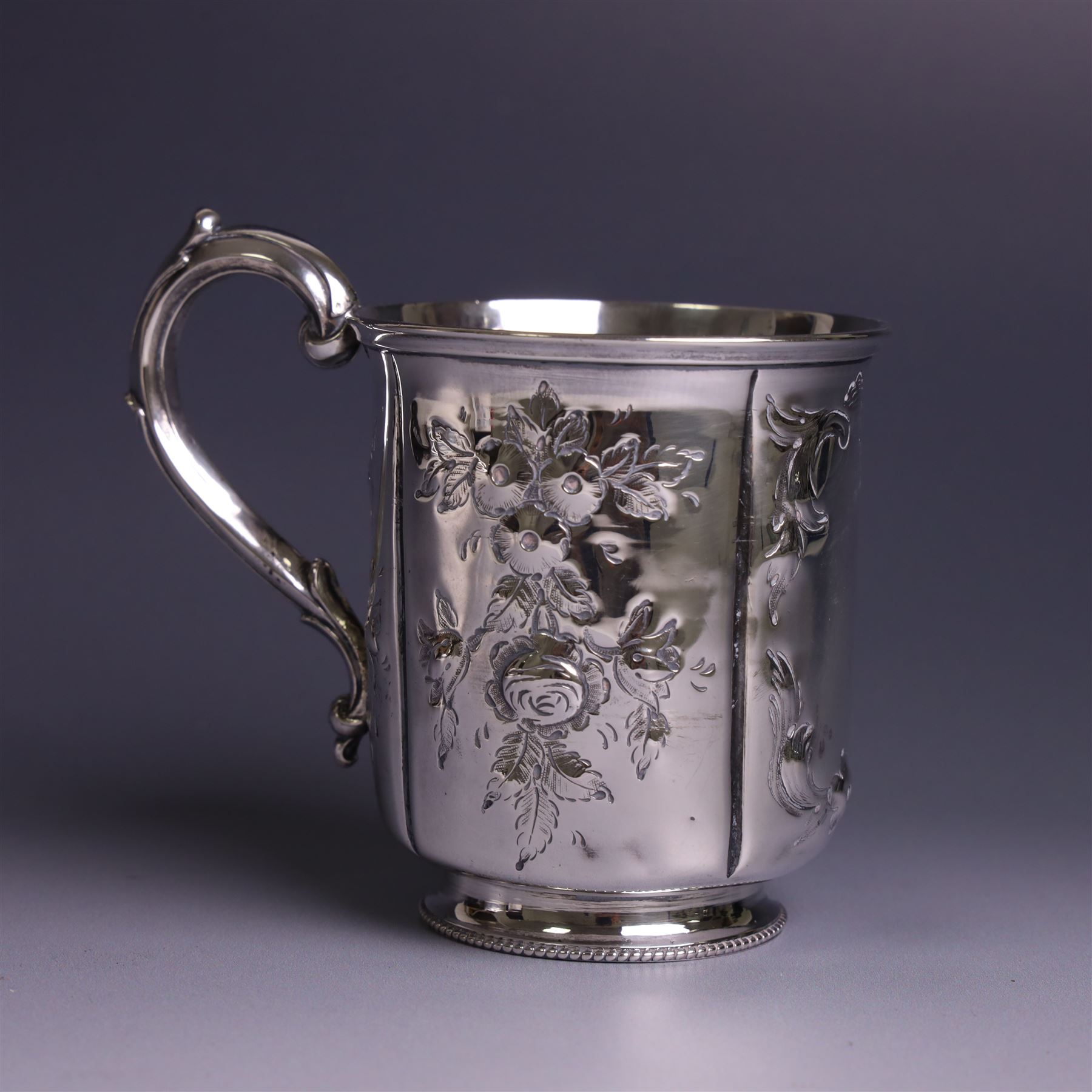 Victorian silver christerning mug, of cylindrical form with four panels of embossed floral decoration, hallmarked H J Lias & Son, London 1876, H10cm