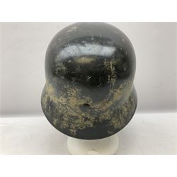 WW2 German steel helmet painted in undecaled Luftwaffe bluey grey with leather liner and chin strap stamped '58', the skirt impressed '1250'