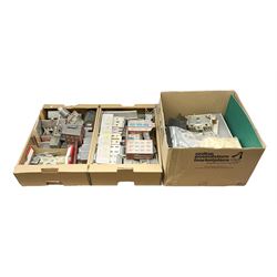 '00' gauge - large quantity of kit-built plastic and card trackside buildings including stations, warehouses, factories, parades of shops, church, houses etc; earlier wooden station building; and large bag of wooden matchsticks for model making; in three boxes