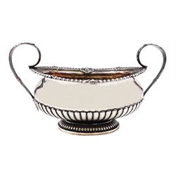 George III silver twin handled sucrier, of part fluted oval form with oblique gadrooned rim with shell and palmette cast detail, twin acanthus mounted curved handles and gilt interior, hallmarked Paul Storr, London, date letter worn and indistinct, including handles H12.5cm bowl L17cm, approximate weight 15.44 ozt (480 grams)