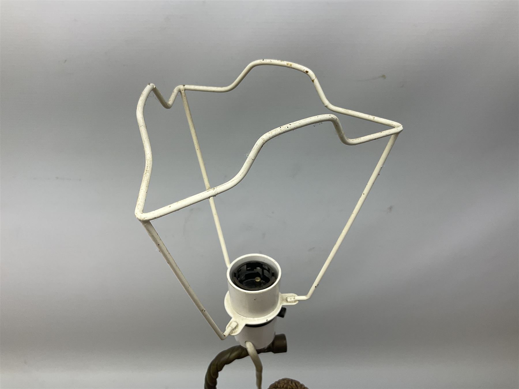 Composite table lamp modelled as a Roman Emperor donning blue robes, upon quatrefoil base modelled with rams heads and winged cherubs, H56cm excl fitting