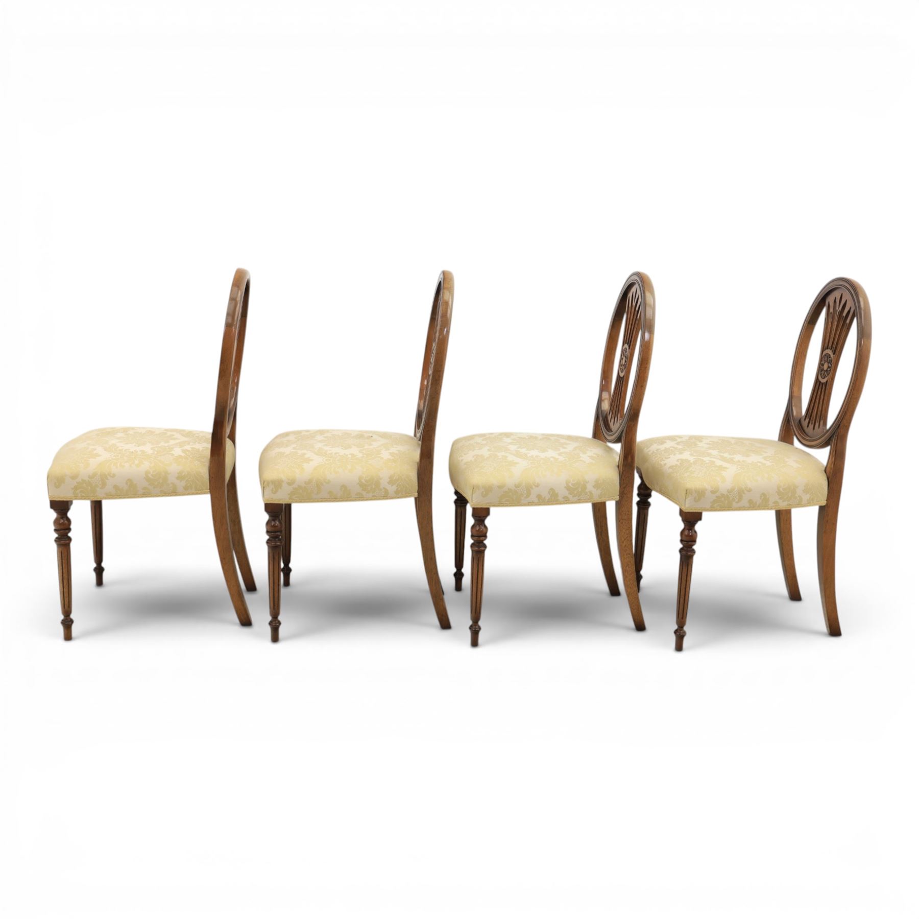 Bevan Funnell Reprodux - Regency design set of ten mahogany dining chairs, oval backs with central splat with rose motif, serpentine seat upholstered in damask fabric, raised on turned supports
