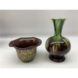 Linthorpe pottery vase with crimped rim and ovoid body, Linthorpe jug with high loop handle and crimped spout, a pair of candlesticks with a green, brown glaze and other similar pottery 