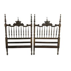 Pair Spanish stained beech single 3' bedsteads, spindle turned backs and carved with scrolling floral decoration 
