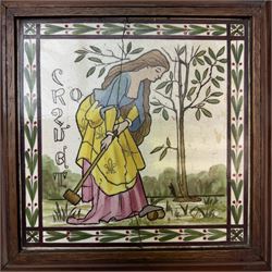Pair of Victorian tiles, the first depicting a man with a pair of hunting dogs, the other a woman playing croquet each within a foliate boarder, within oak frames, H25cm, 
