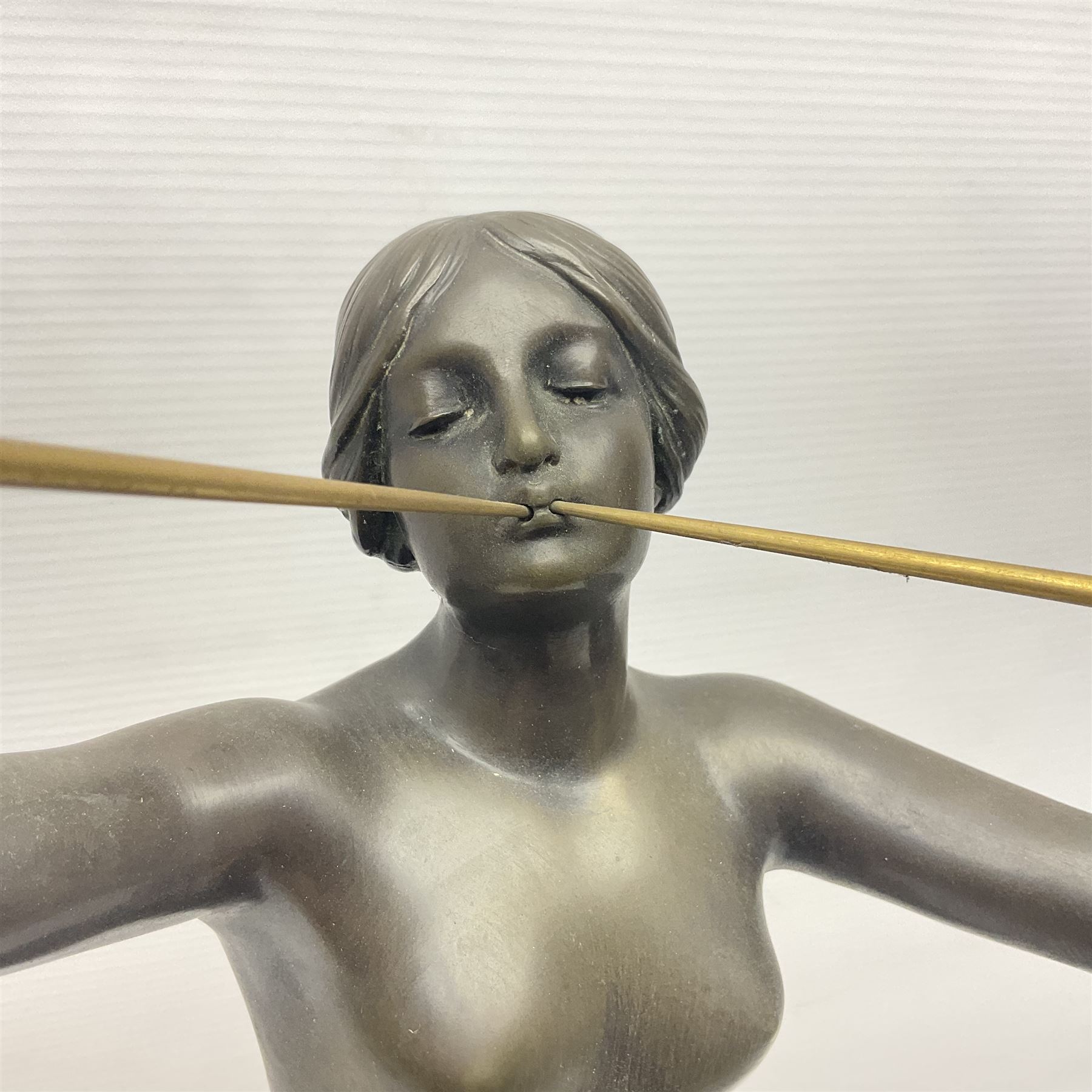 After Eugen Schlipf, Fanfair, bronzed female figure playing two horns, upon a circular marble plinth, H57cm